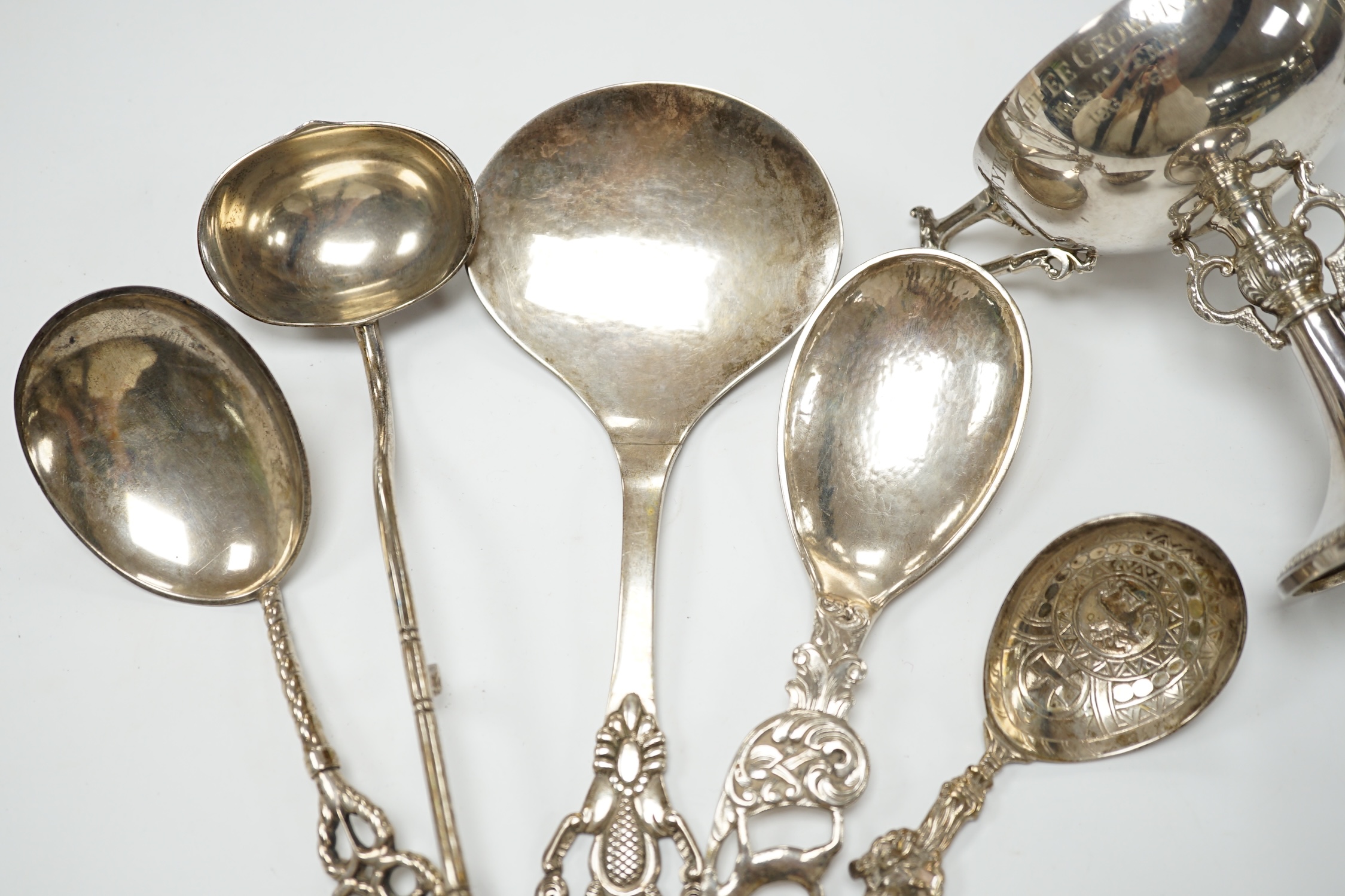 Five assorted early to mid 20th century Danish 830S spoons, largest 21.1cm, together with an Elizabeth II silver two handled presentation trophy cup with engraved inscription relating to the 'Tanganyika Coffee Growers As